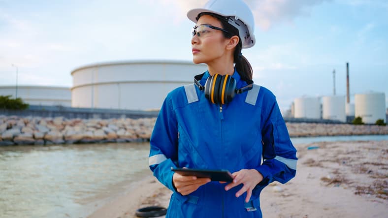 Female petroleum engineer looking over her shoulder.