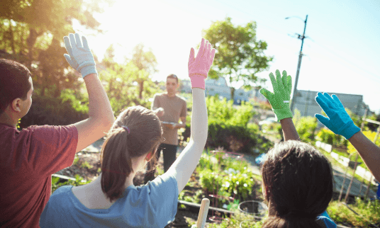 Teacher calling on students with their hand raised.