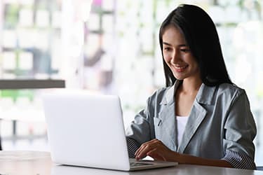 Woman smiling at laptop